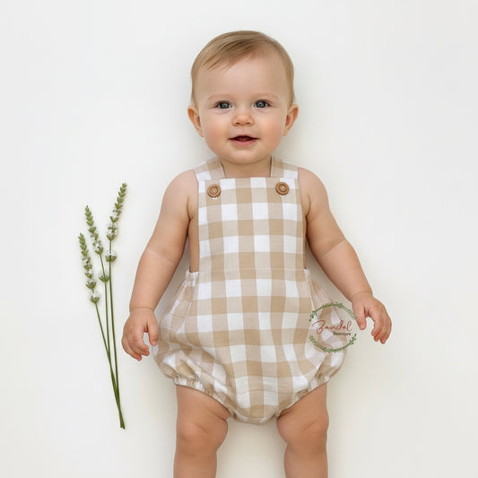 Plaid baby romper with button details on a white background