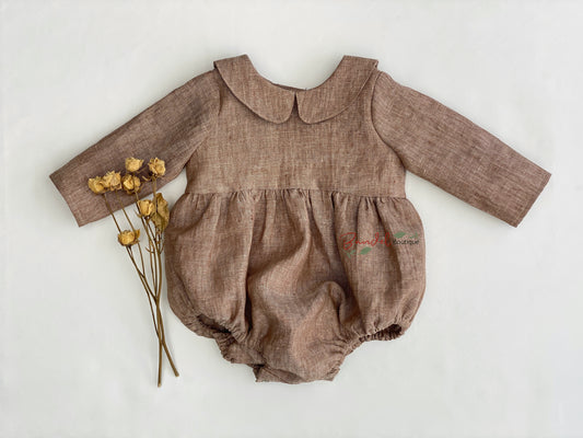 A timeless classic, this brown linen playsuit Romper is the perfect outfit for your baby. Featuring a Peter Pan collar, elastic at the leg openings, wooden buttons at the back and snaps at the crotch for easy nappy changing, this stylish playsuit will keep your little one comfortable and looking their best.