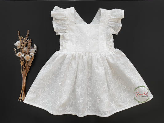 Embroidery Ivory Vintage Dress is crafted from cotton and features delicate sleeve ruffles, adjustable straps, and a gathered skirt. Perfect for the little flower girl, this ivory dress is sure to add a touch of timeless elegance to your special day.