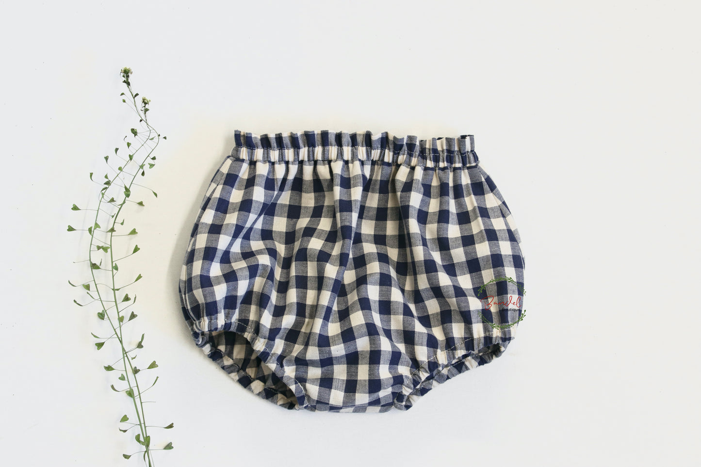 Navy Blue Cotton Bloomers are designed to keep baby and toddlers comfortable. Crafted from 100% cotton, the navy blue check pattern bloomer provides a stylish, yet comfortable fit. An ideal addition to your little one's wardrobe. Designed with frills detail at the waist and elastic waistband and leg cuffs to ensure a perfect fit for your baby or toddler.