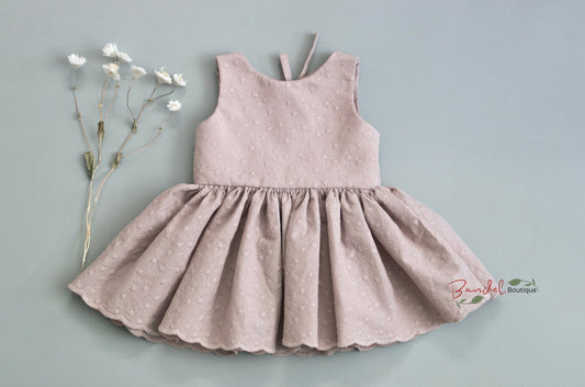 Old-Rose Embroidery Dress features a simple front bodice crafted from old rose embroidered cotton. The back of the bodice is designed with two rows of elastic and a large opening with bow-ties. Its comfortable fit and timeless elegance make it a must-have for every little girl's wardrobe.