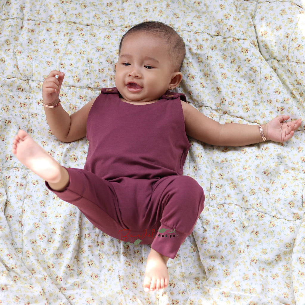 Baby wearing dusty bordeaux harem romper 