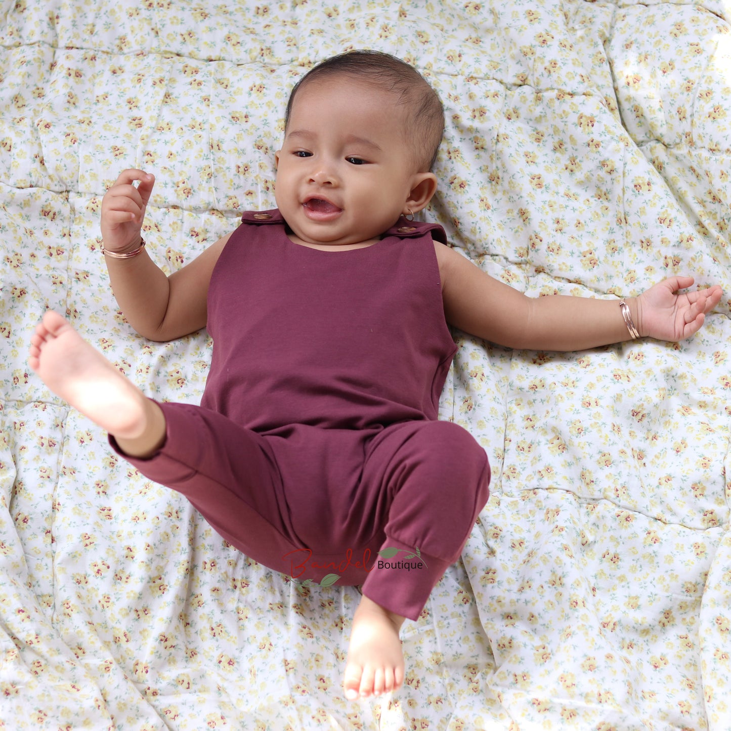 Baby wearing dusty bordeaux harem romper 