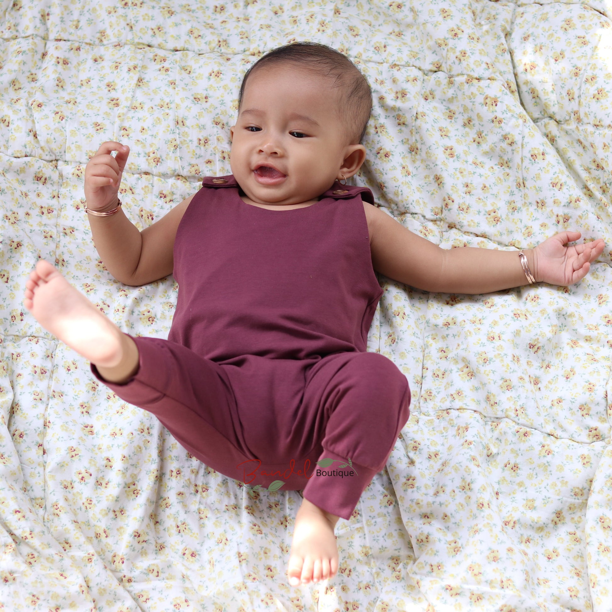 Baby wearing dusty bordeaux harem romper 