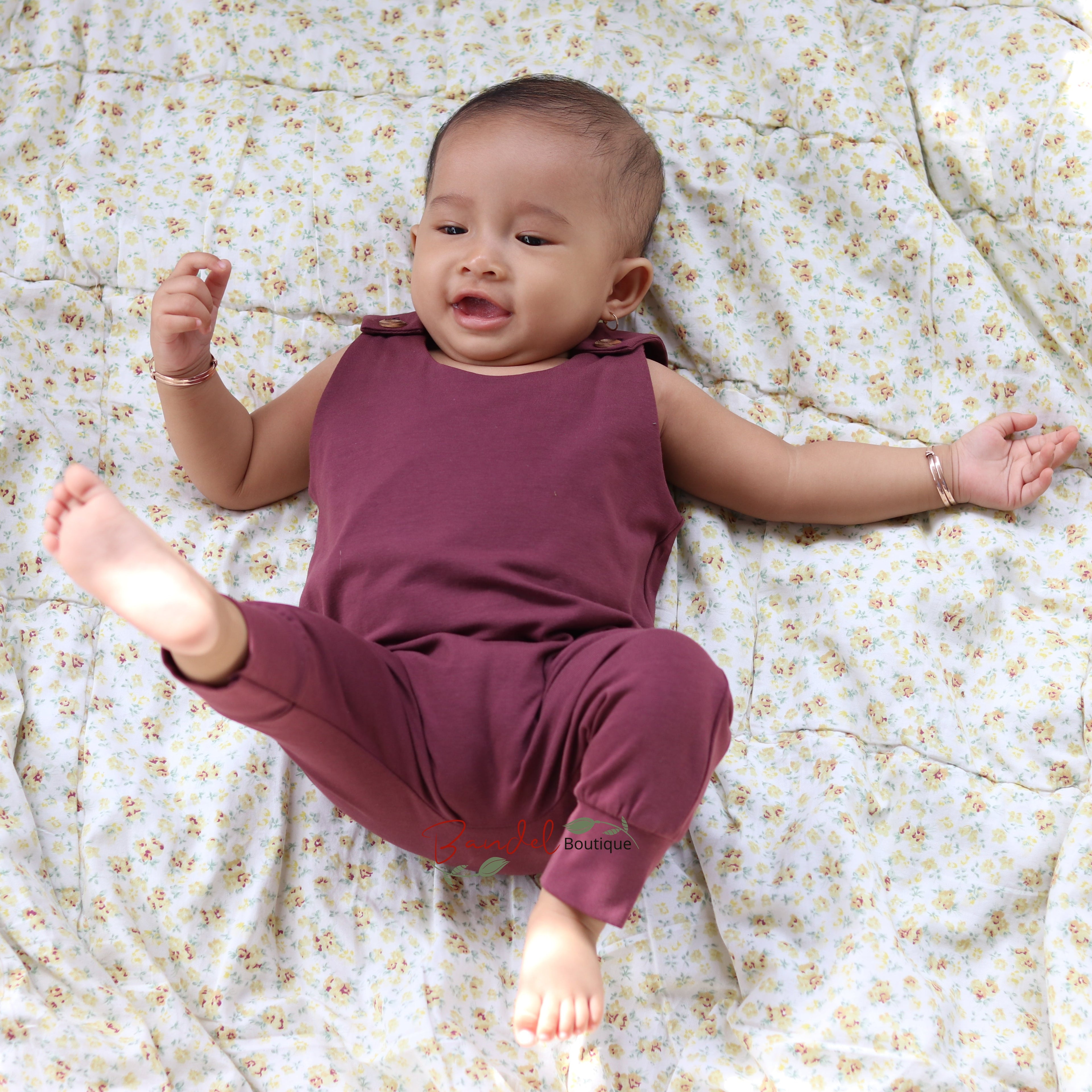 Baby wearing dusty bordeaux harem romper 