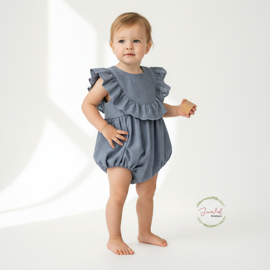 Baby wearing a blue ruffled romper on a white background
