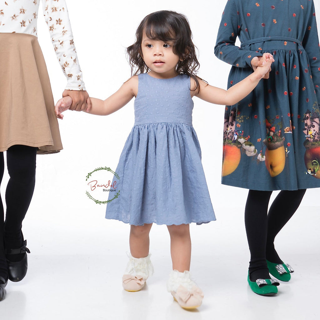 Blue Embroidery Cotton Dress features a simple front bodice with two rows of elastic banding and a large opening with bow-ties at the back for comfort and a timeless effect. The knee-length full skirt is crafted from 100% cotton and ensures a comfortable fit. This dress is perfect for any special occasion.