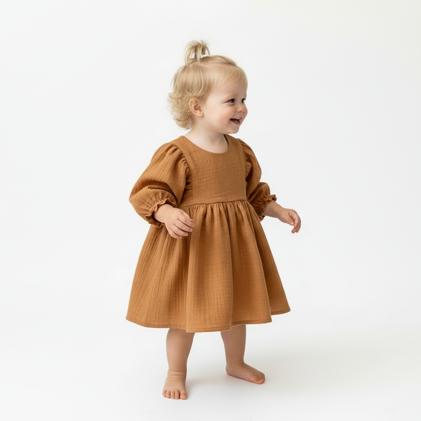 Child wearing a brown dress on a white background