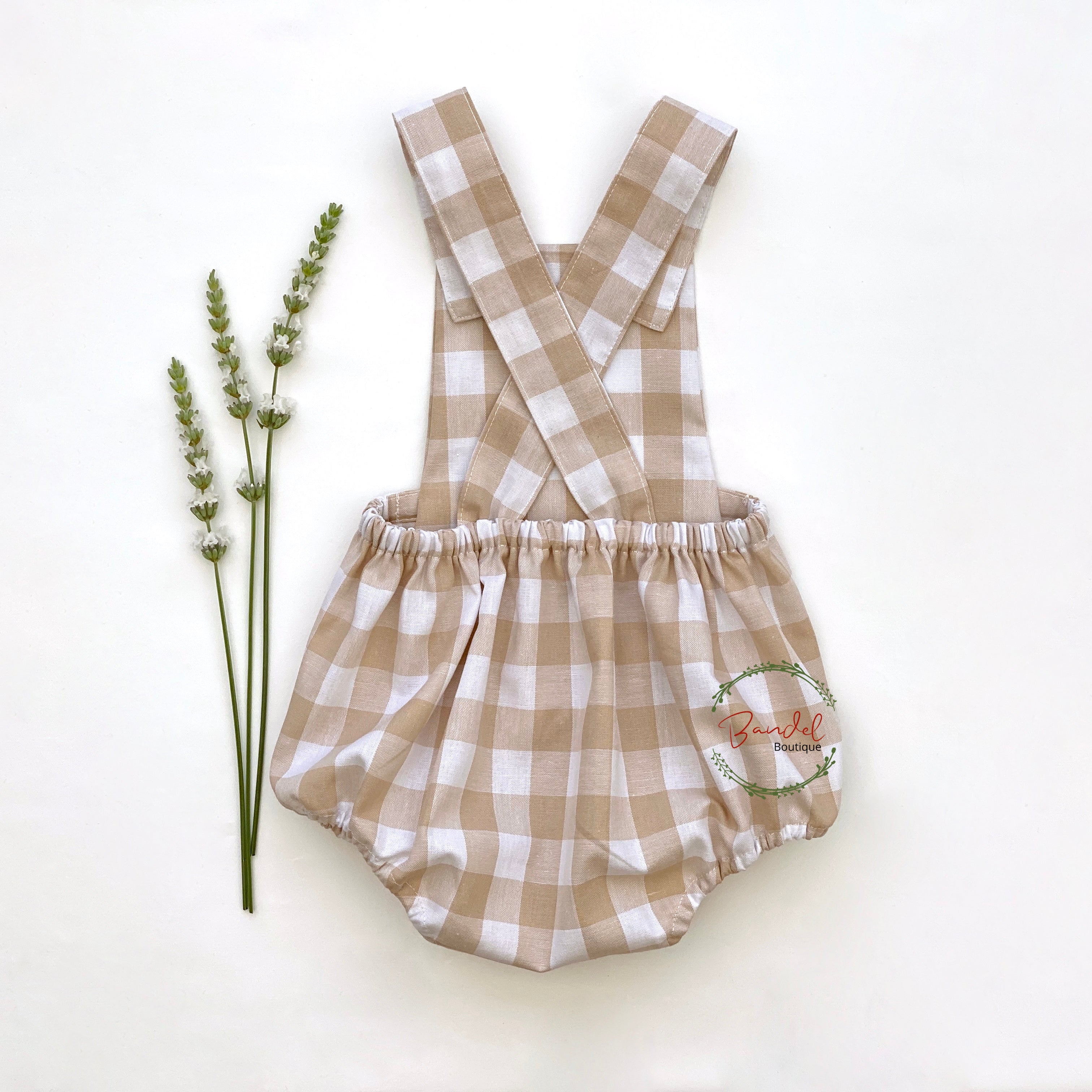 Plaid romper with a logo on a white background