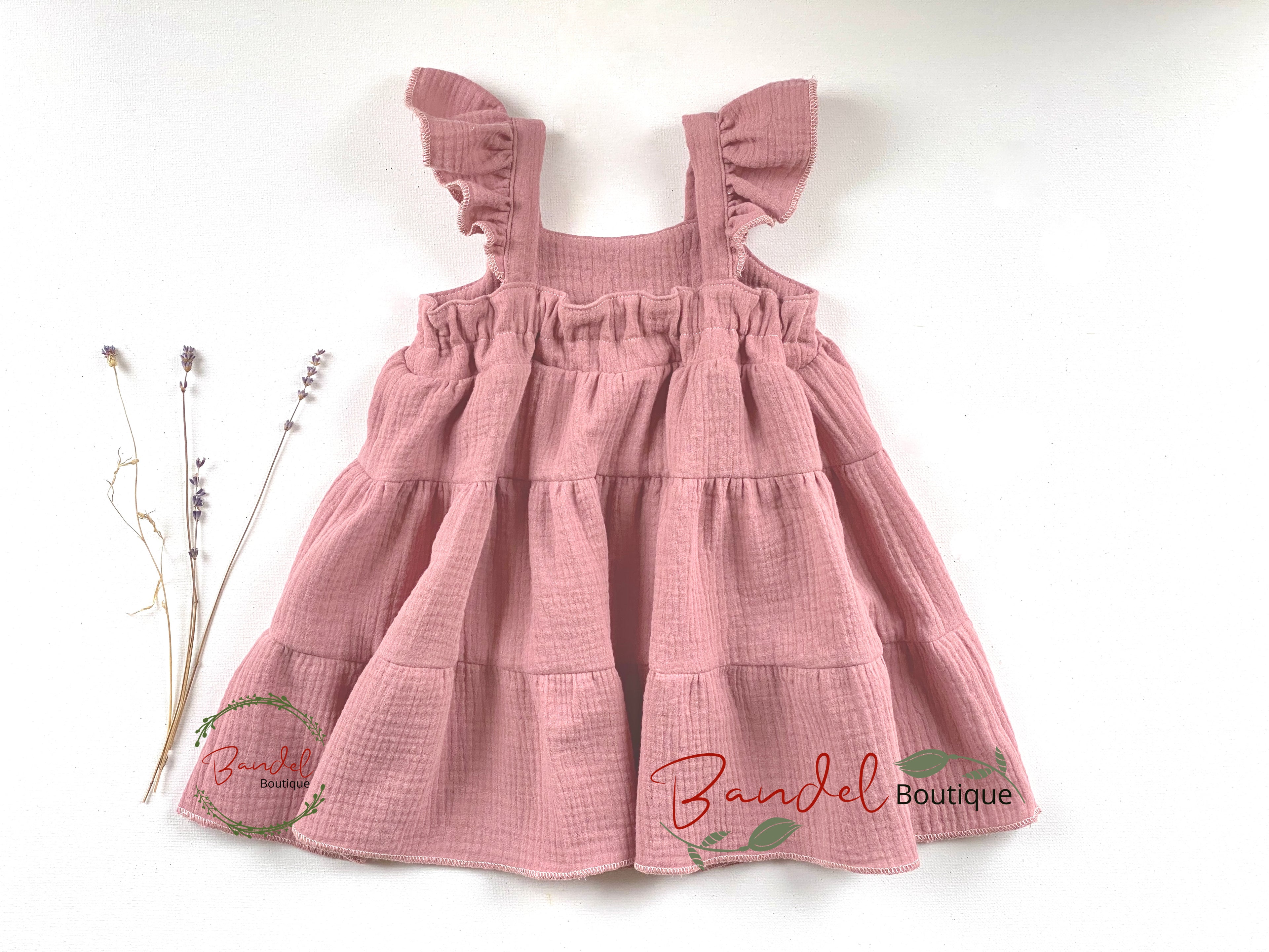 Pink dress with ruffled straps on a white background, featuring 'Banel Boutique' branding.