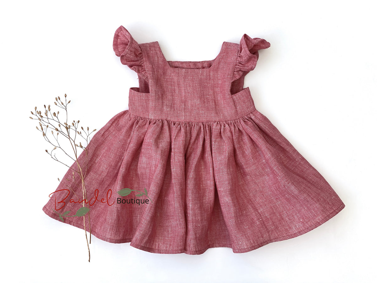 Red dress with ruffled straps on a white background, featuring 'Bella Del' logo.
