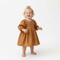 Child wearing a brown dress on a white background