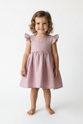 Young girl wearing a pink dress on a white background