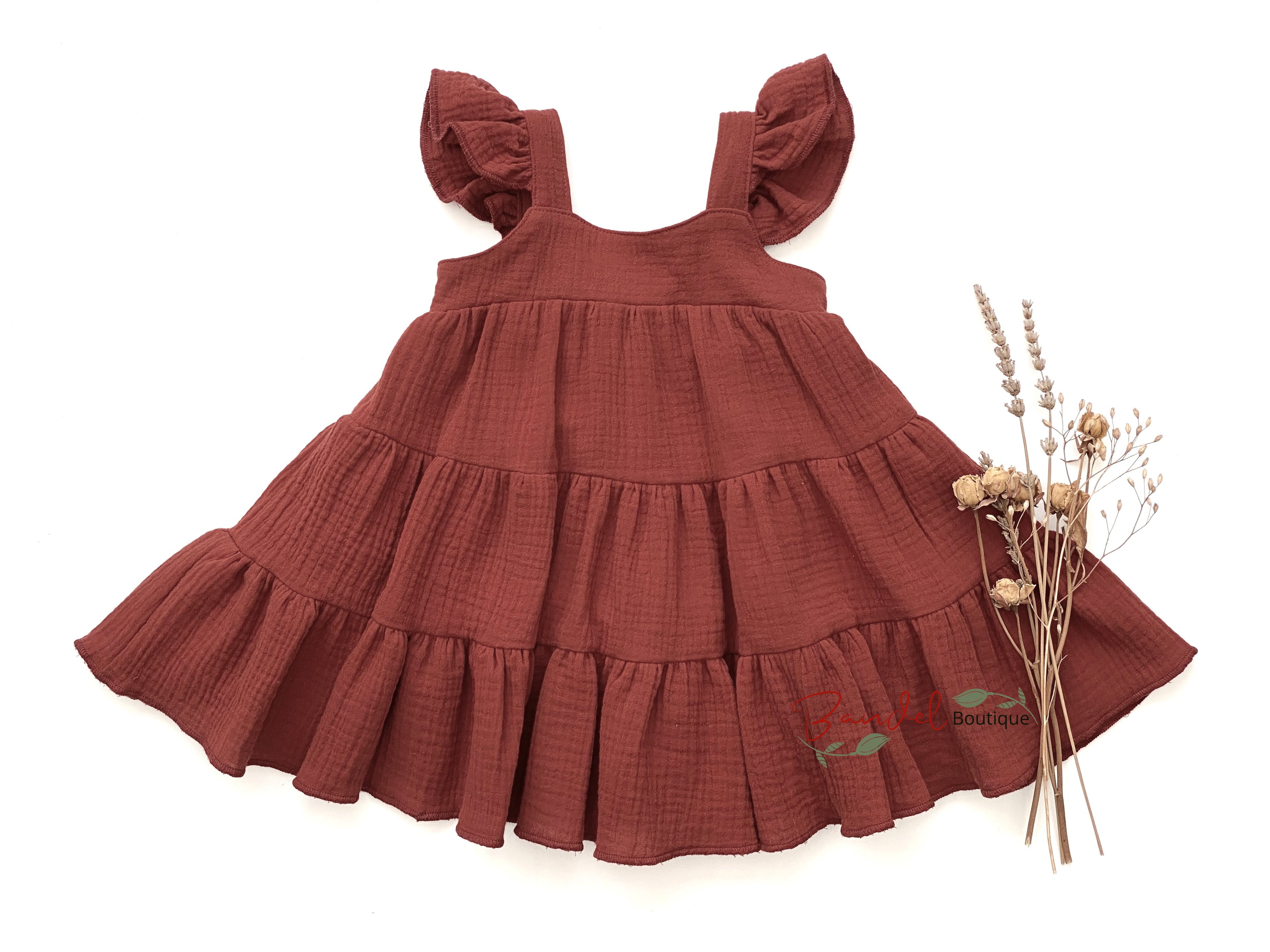 Brown tiered dress with ruffled sleeves on a white background