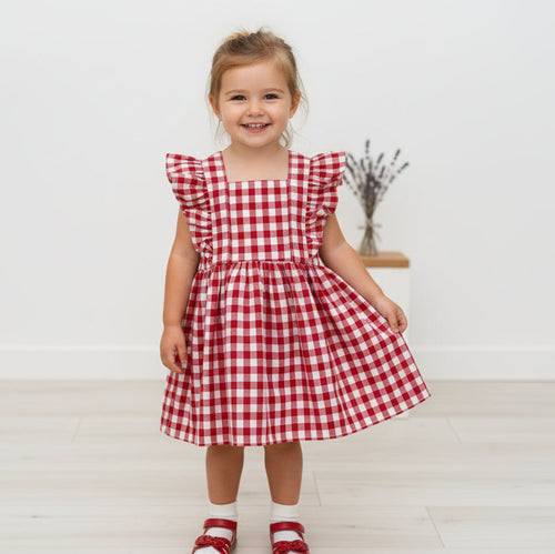 Classic Red Gingham Vintage Dress for girls features adjustable straps, ruffled sleeves, and a full gathered skirt for a timeless look.