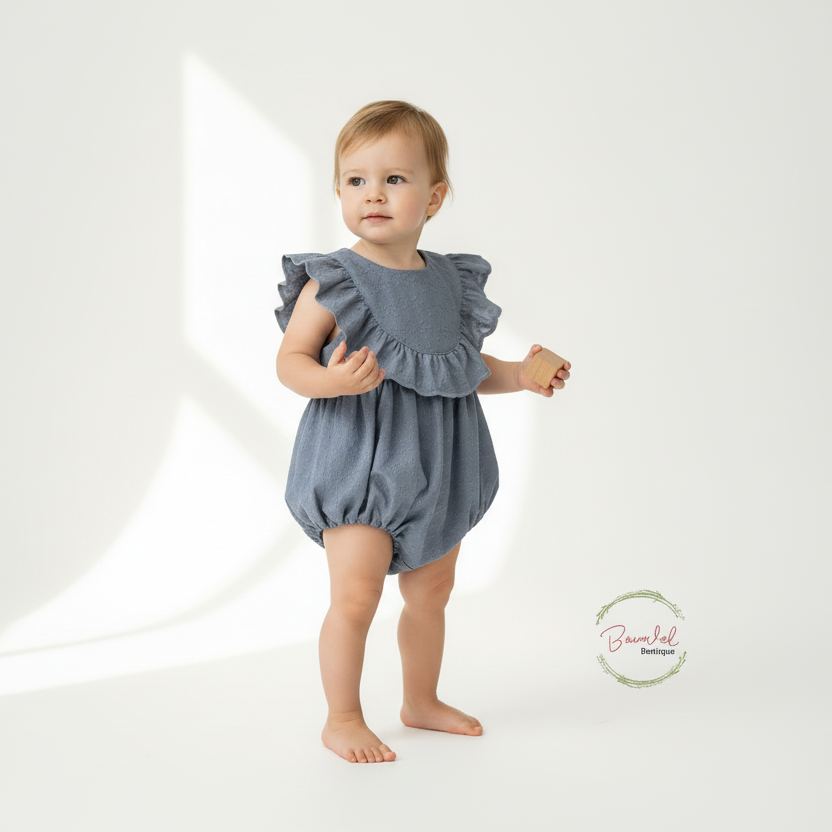 Baby wearing a blue ruffled romper on a white background