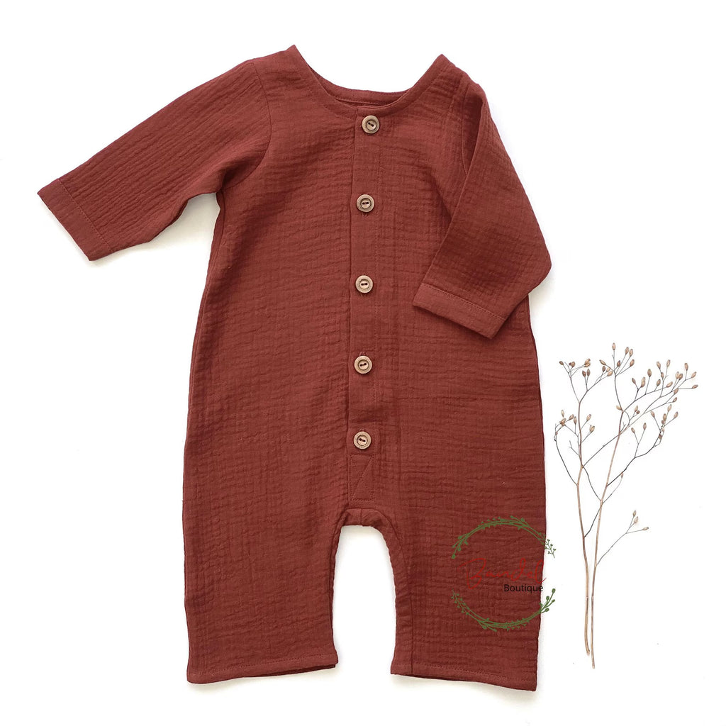 Brown baby romper with buttons on a white background