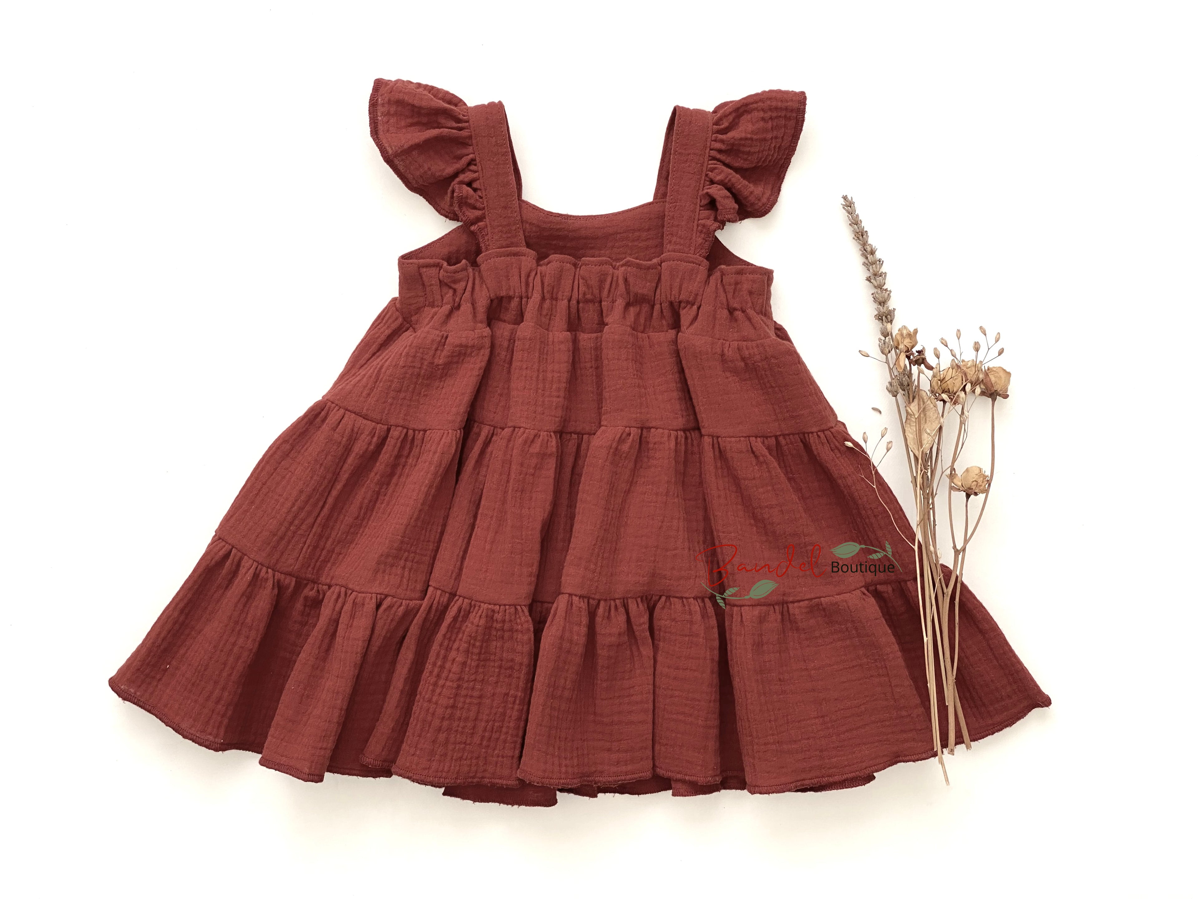 Brown tiered dress with ruffled straps on a white background