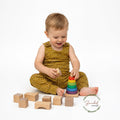 Child playing with wooden toys on a white background